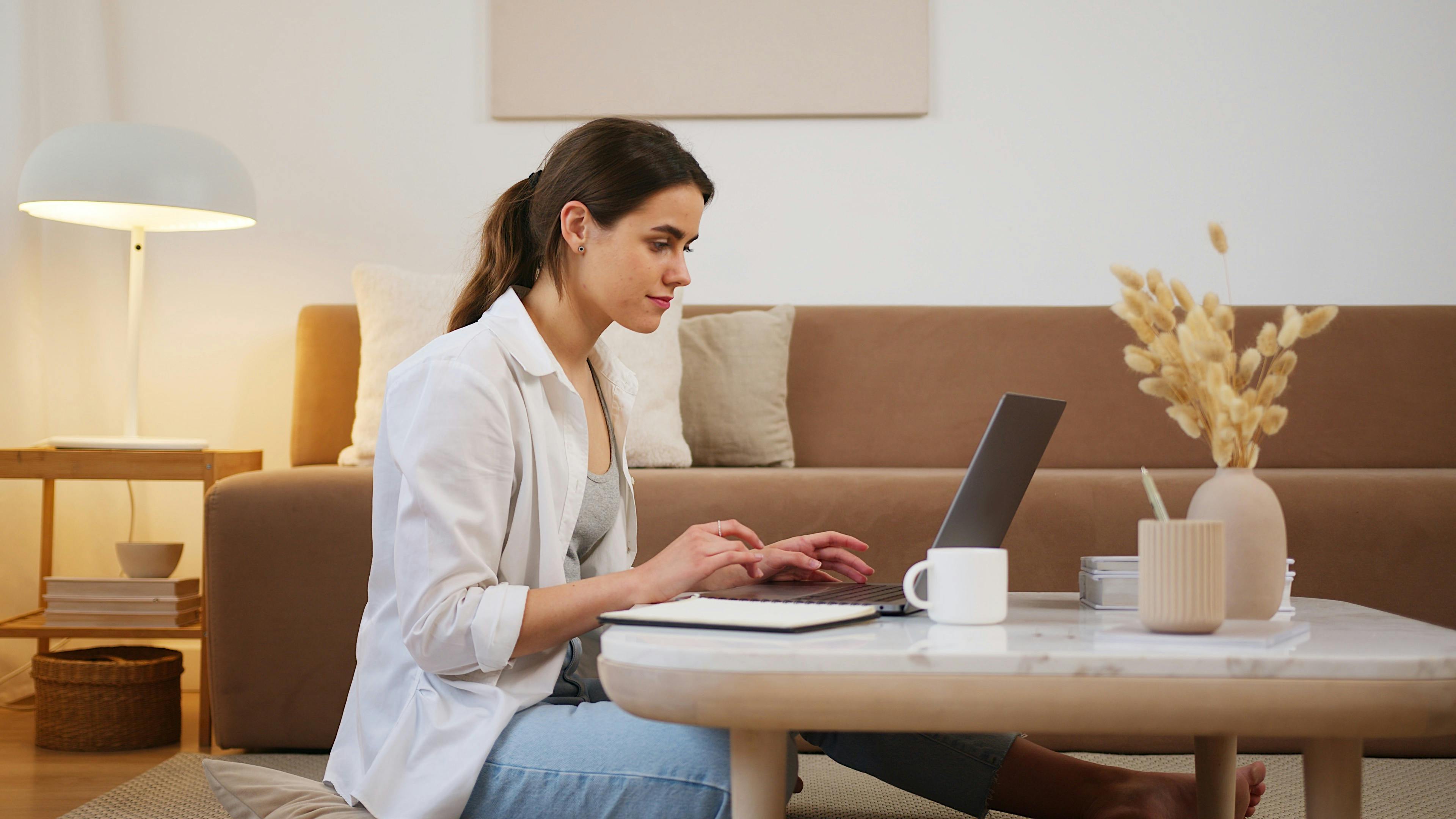 Donna concentrata al computer durante una lezione o sessione di coaching online, simbolo della formazione personalizzata e flessibile offerta da Course Clear.