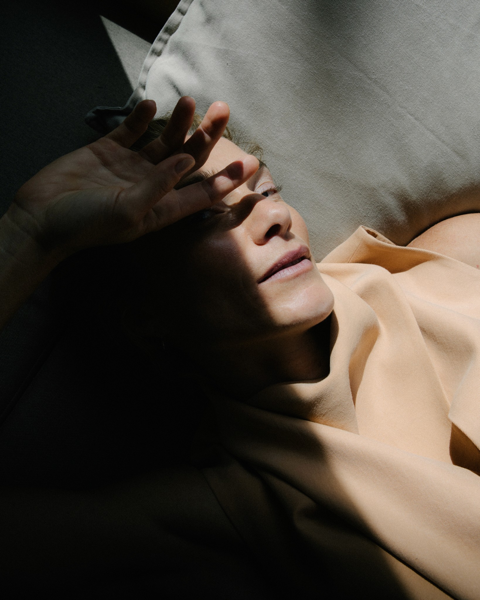 Frau entspannt auf Couch im Sonnenlicht