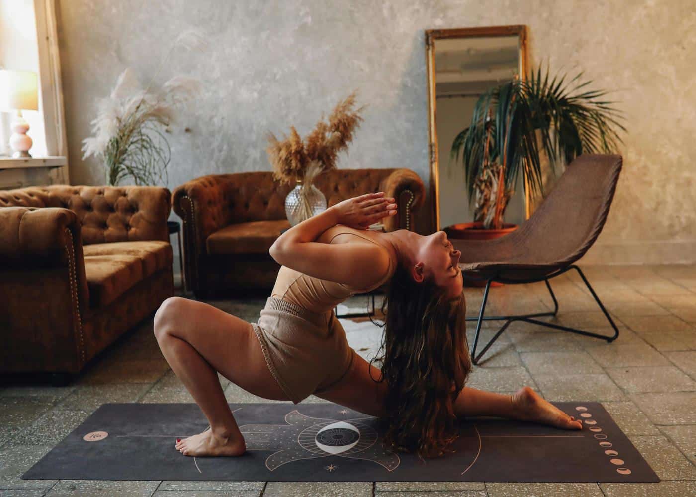 What is Vinyasa yoga - woman performing a flow yoga pose at home