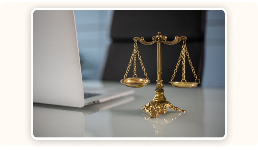 Golden scales of justice next to laptop