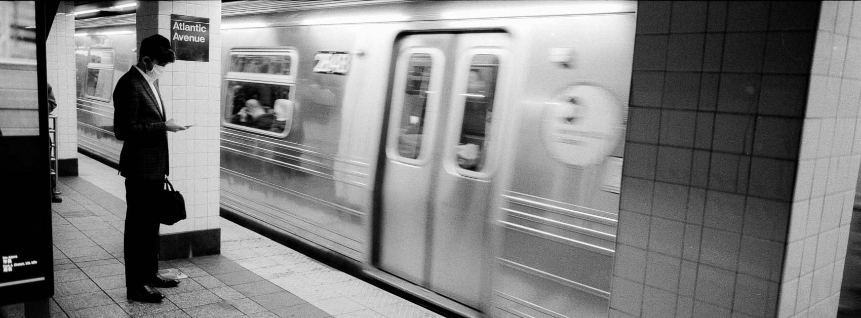 NYC pictures black and white subway tension, panoramic Hasselblad XPan street chaos.