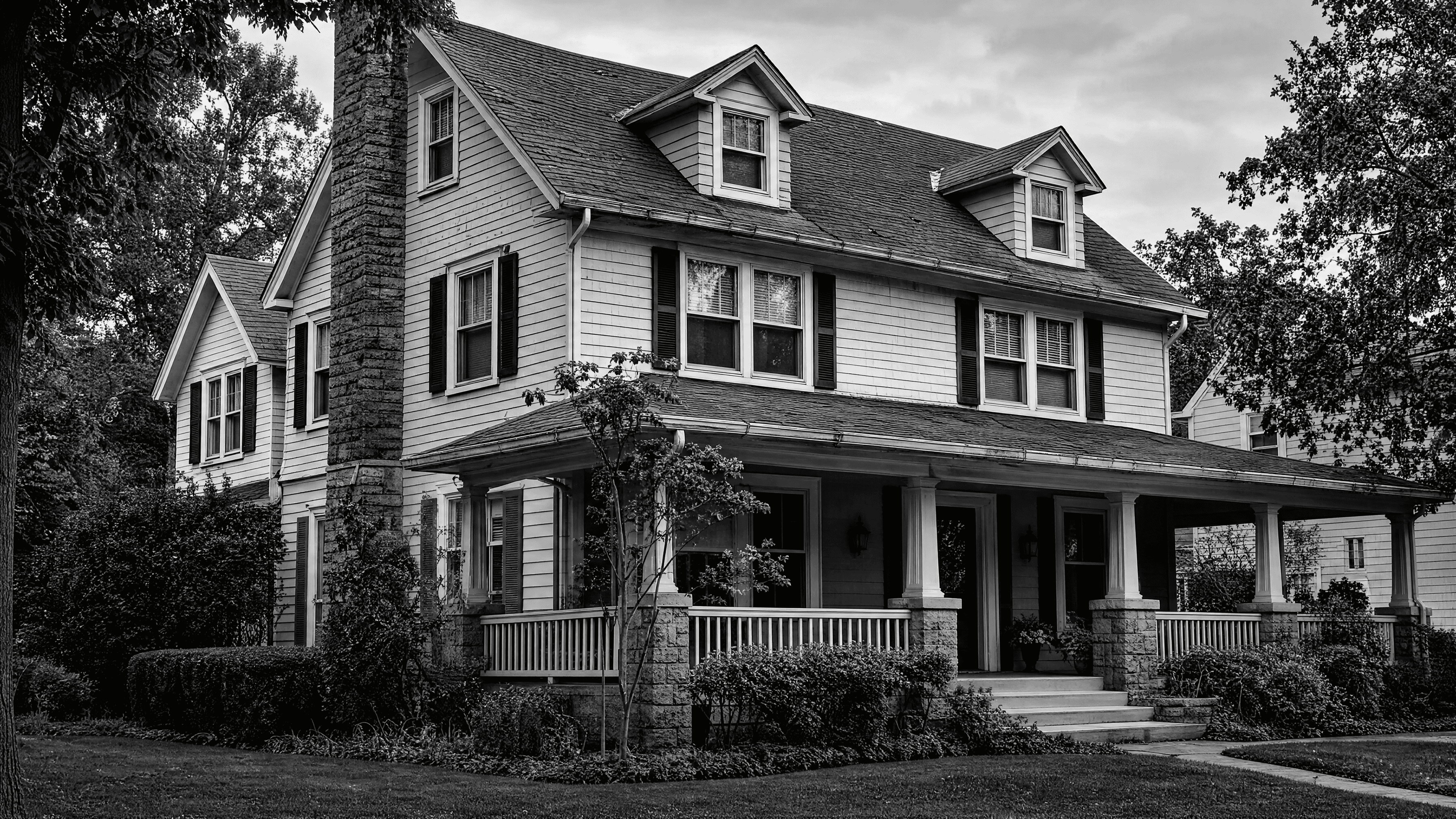 Older two-story home showing visible wear across the roof, gutters, siding, windows, and exterior trim.