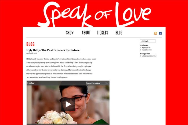 A screenshot of the Speak of Love website shows a red background with the website’s title in white stylized letters at the top. Below the title are tabs labeled “SHOW,” “ABOUT,” “TICKETS,” and “BLOG.” A search bar labeled “Search” is positioned to the right. A blog post titled “Ugly Betty: The Past Presents the Future” by April 10th, 2010, is displayed on the left side. The post includes a video thumbnail of a woman wearing sunglasses and holding a bouquet of flowers. The post’s archived entries list April 2010 and March 2010. A sidebar labeled “Categories” lists “Uncategorized (6).” The overall layout is clean and organized.