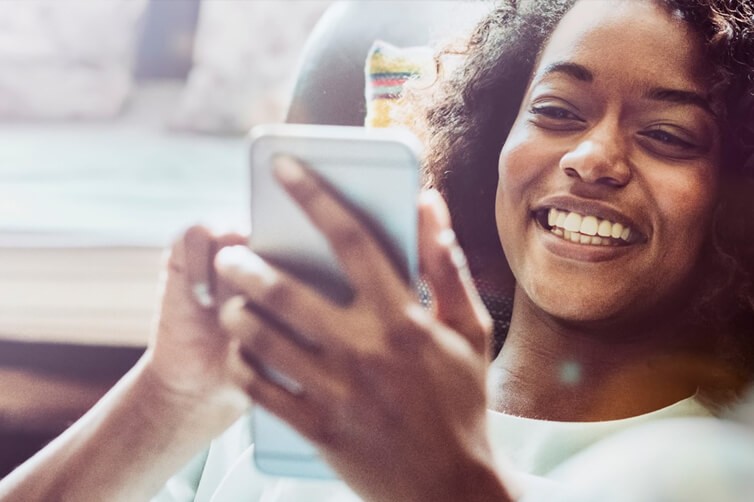 Smiling woman looking at smartphone