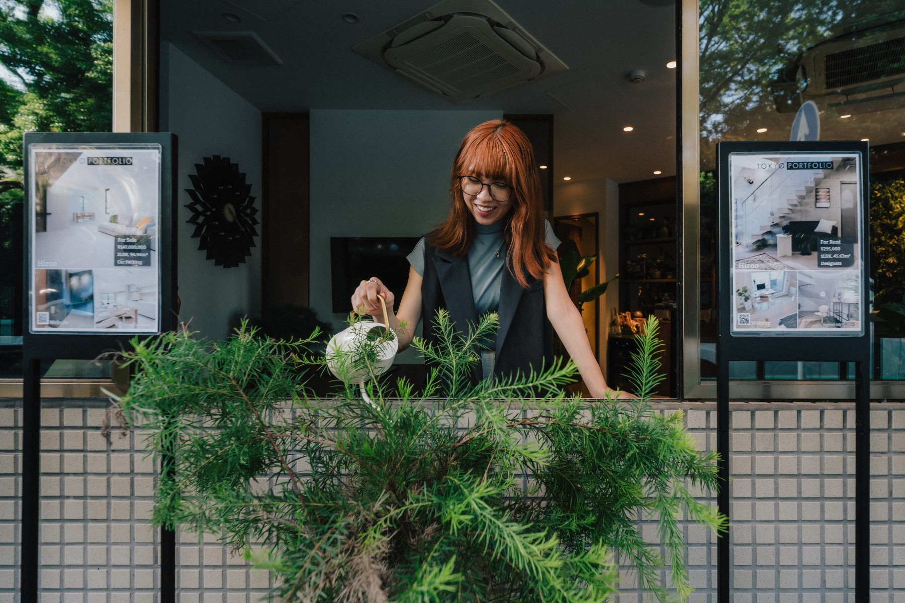 Real estate agent watering the plants at Tokyo Portfolio