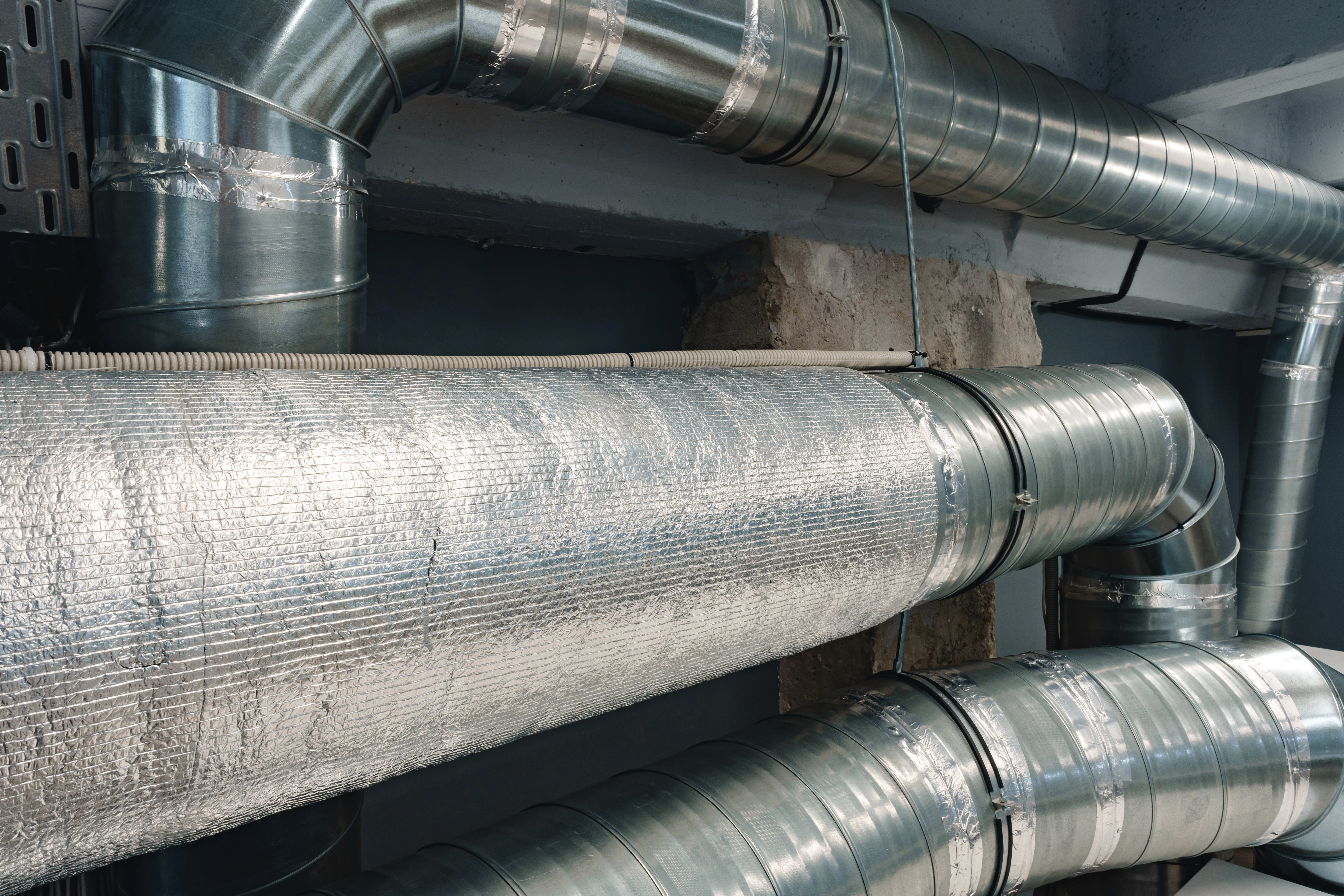 Reflective bubble foil insulation wrapped on HVAC duct in a tight confined mechanical space