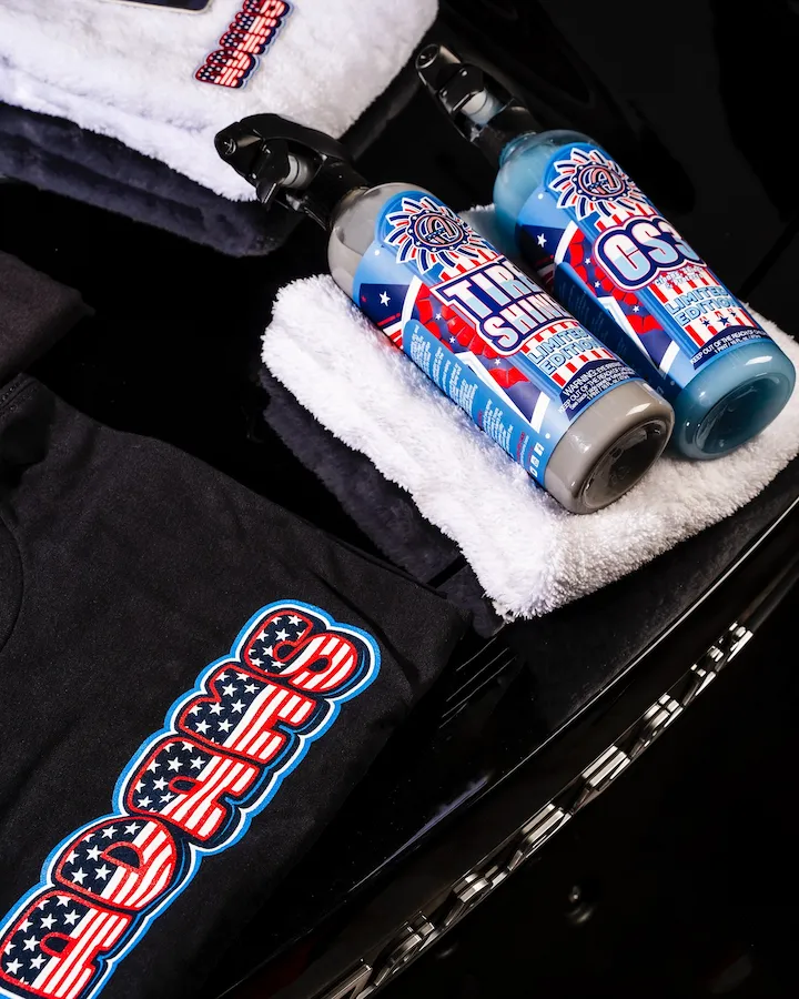 Adam's Polishes limited edition USA Tire Shine and CS3 spray bottles with patriotic label design against a fireworks background — packaging design by Slow Knife Design