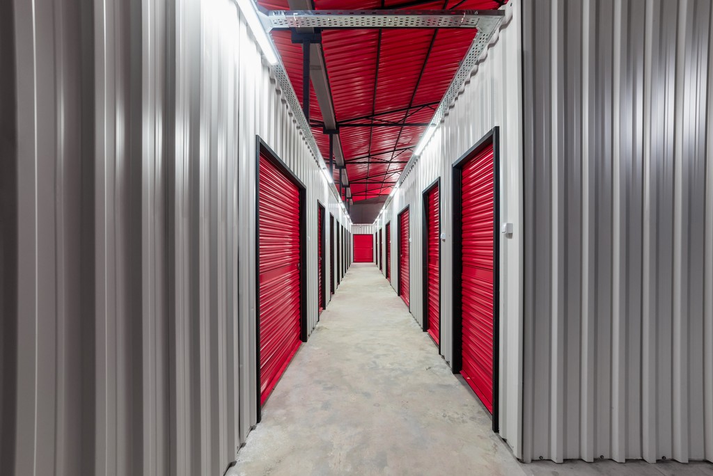 An organised and spacious ARENA business storage hallway with secured doors of a self-storage unit warehouse