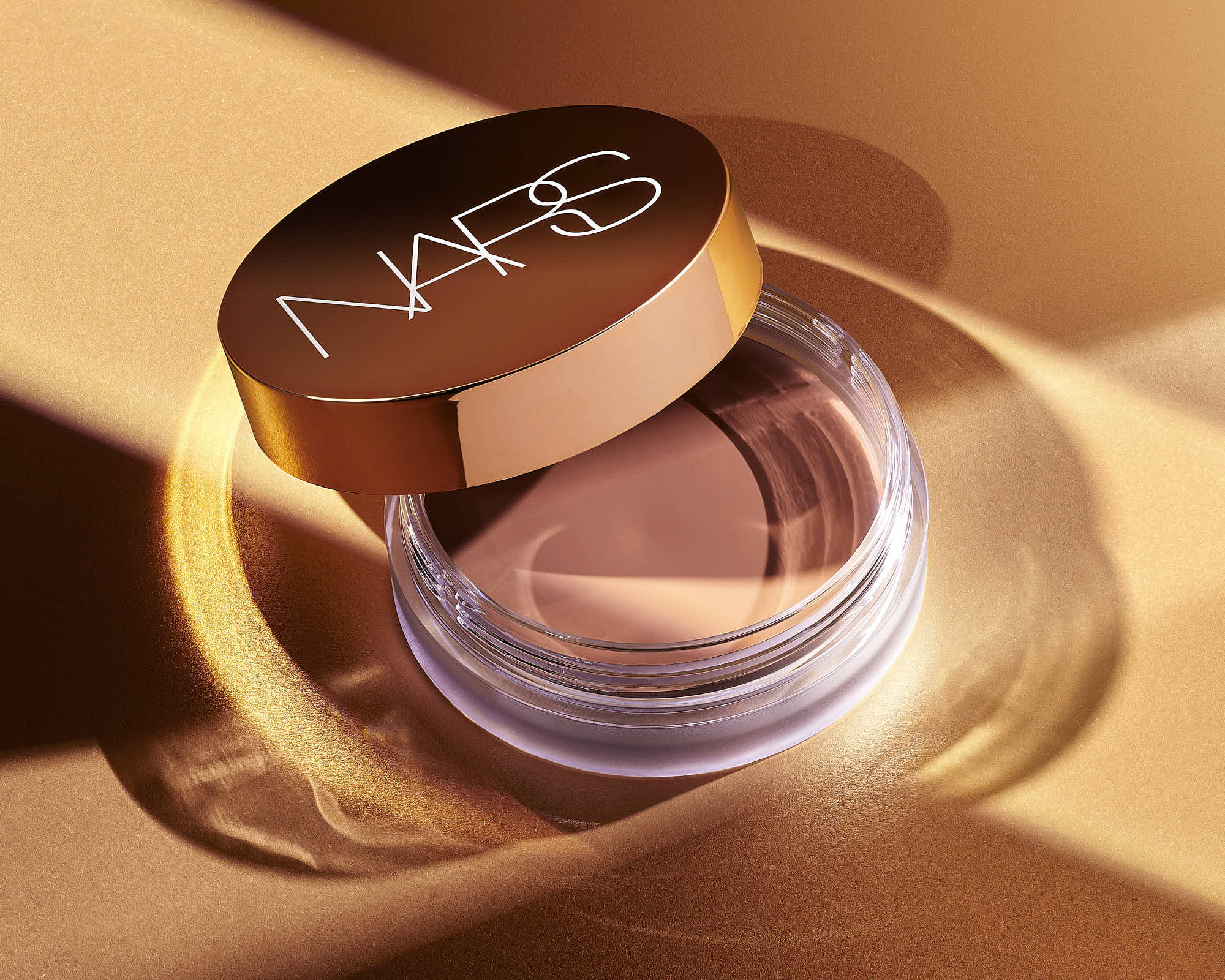 Luxury makeup product in elegant jar with a sleek logo design.