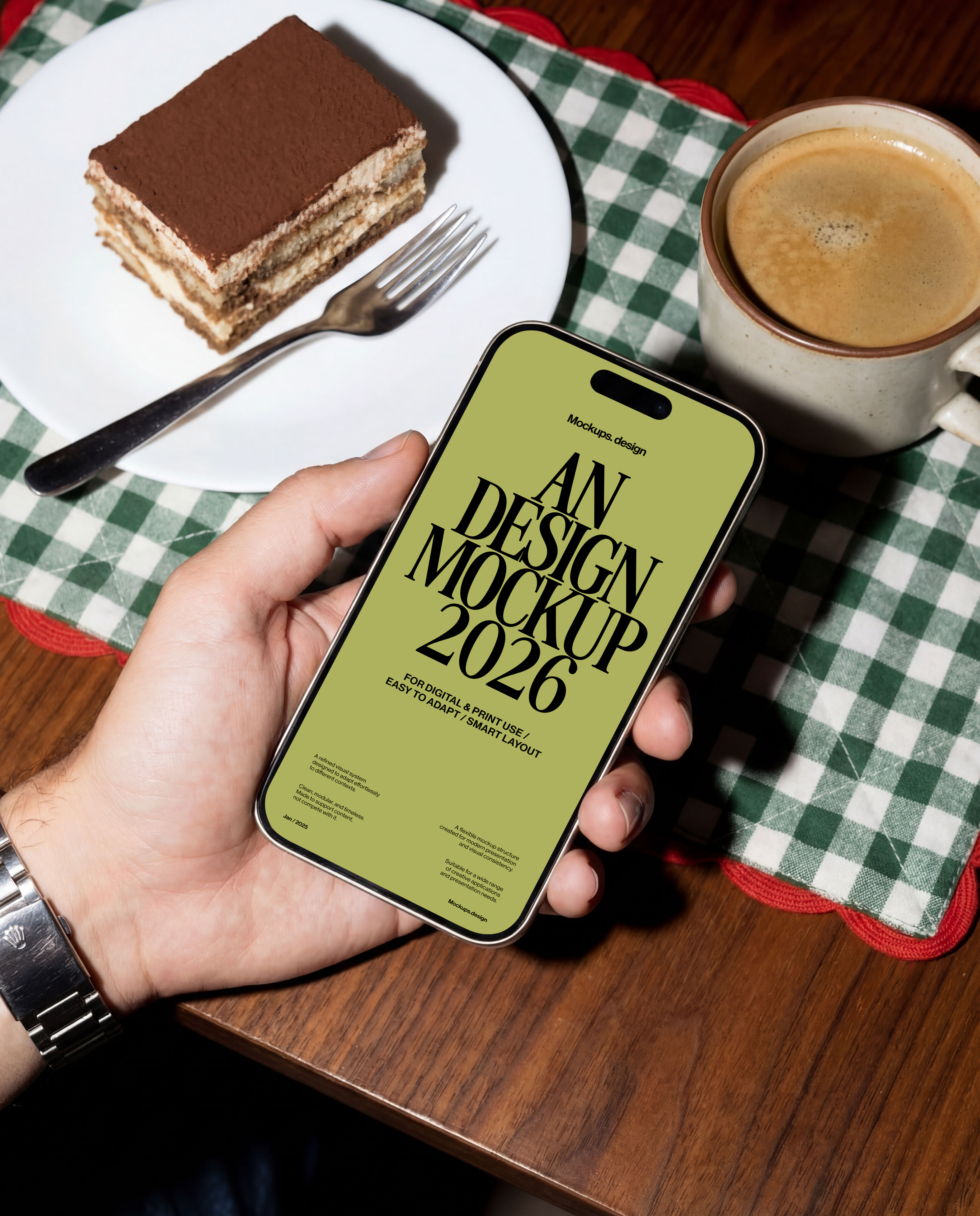 Hand holding iPhone 16 mockup at restaurant table