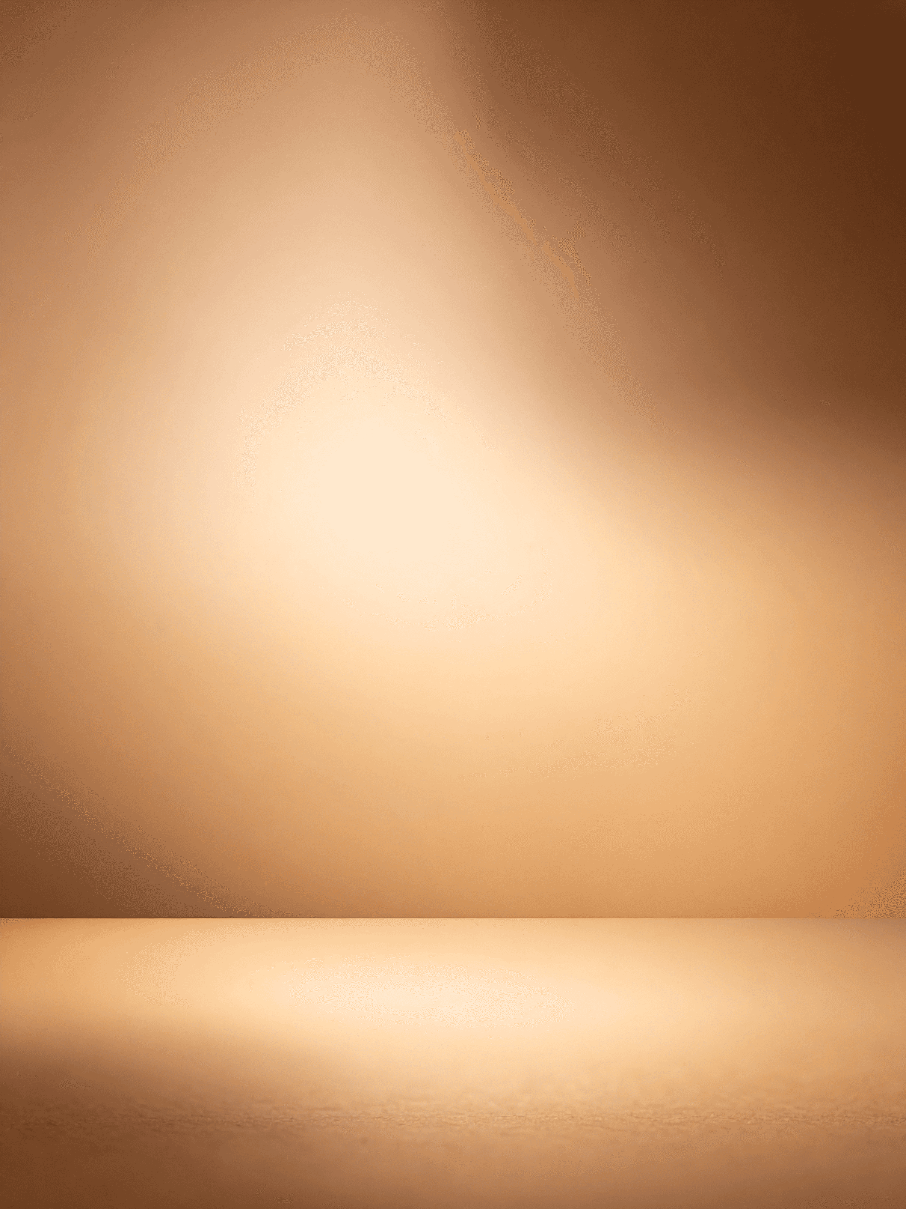 A winding road cuts through rocky terrain, surrounded by patches of green grass and illuminated by sunlight.