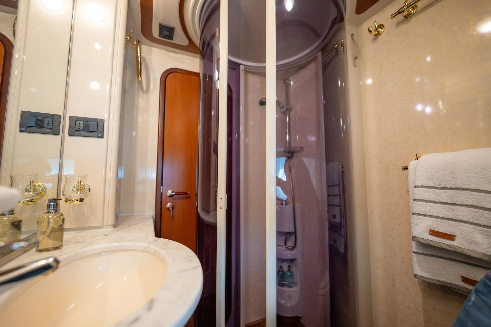 White Rock 36 speedboat with captain at helm cruising calm blue waters near Paros coastline with hills in background.