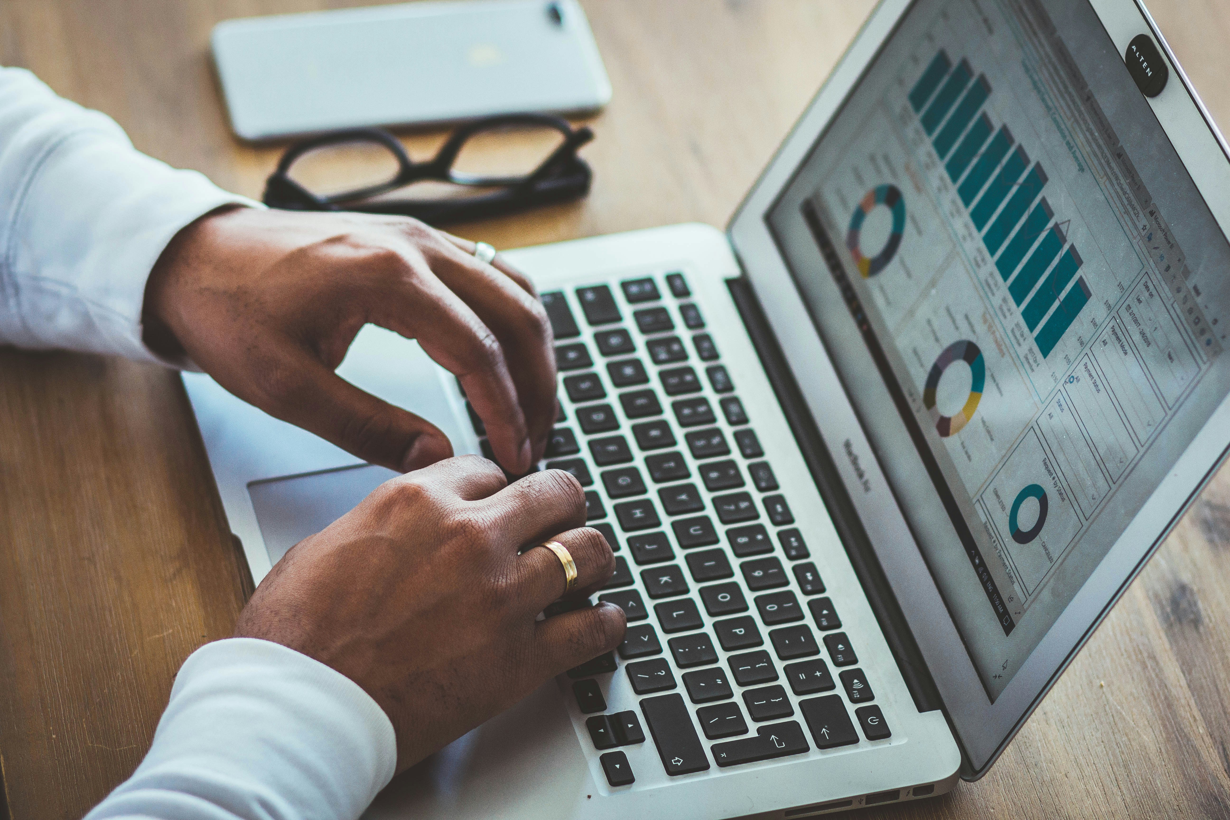 Man checking how they convert suspects to prospects on laptop