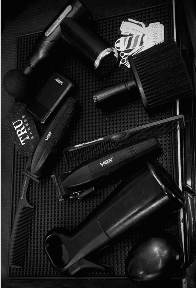 black leather barber chair near brown brick wall