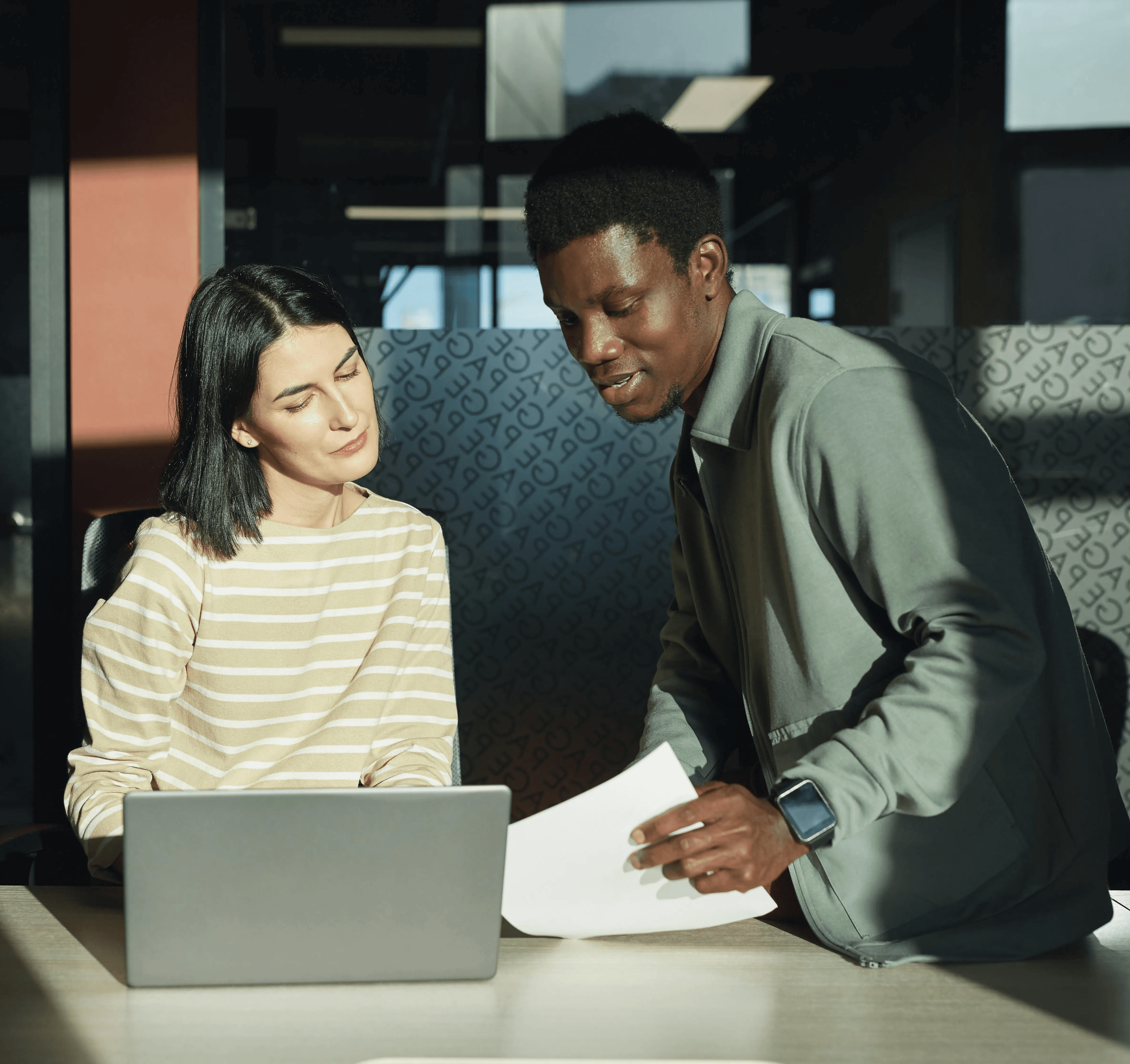 Two expat professionals collaborating in an office, building network connections in Germany