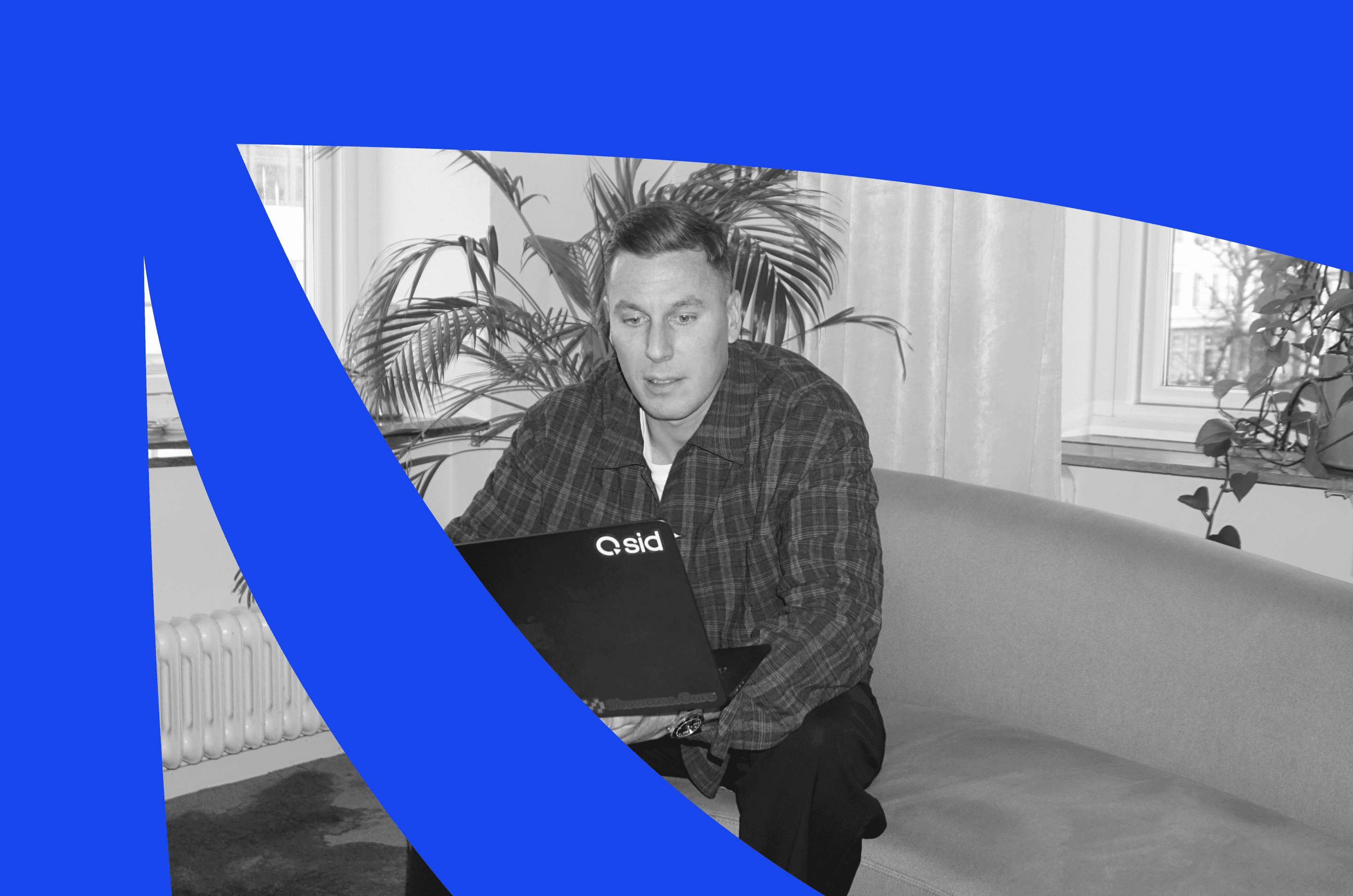 Person sitting on a sofa with a Qsid laptop, symbolizing a complete personal branding playbook for B2B leaders in 2026