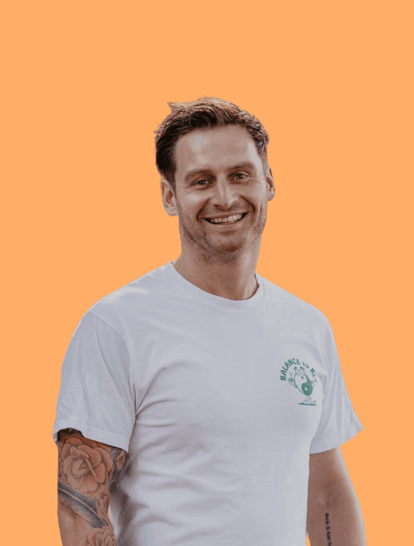 Person, holding a white rose behind his back with one arm on a light blue background