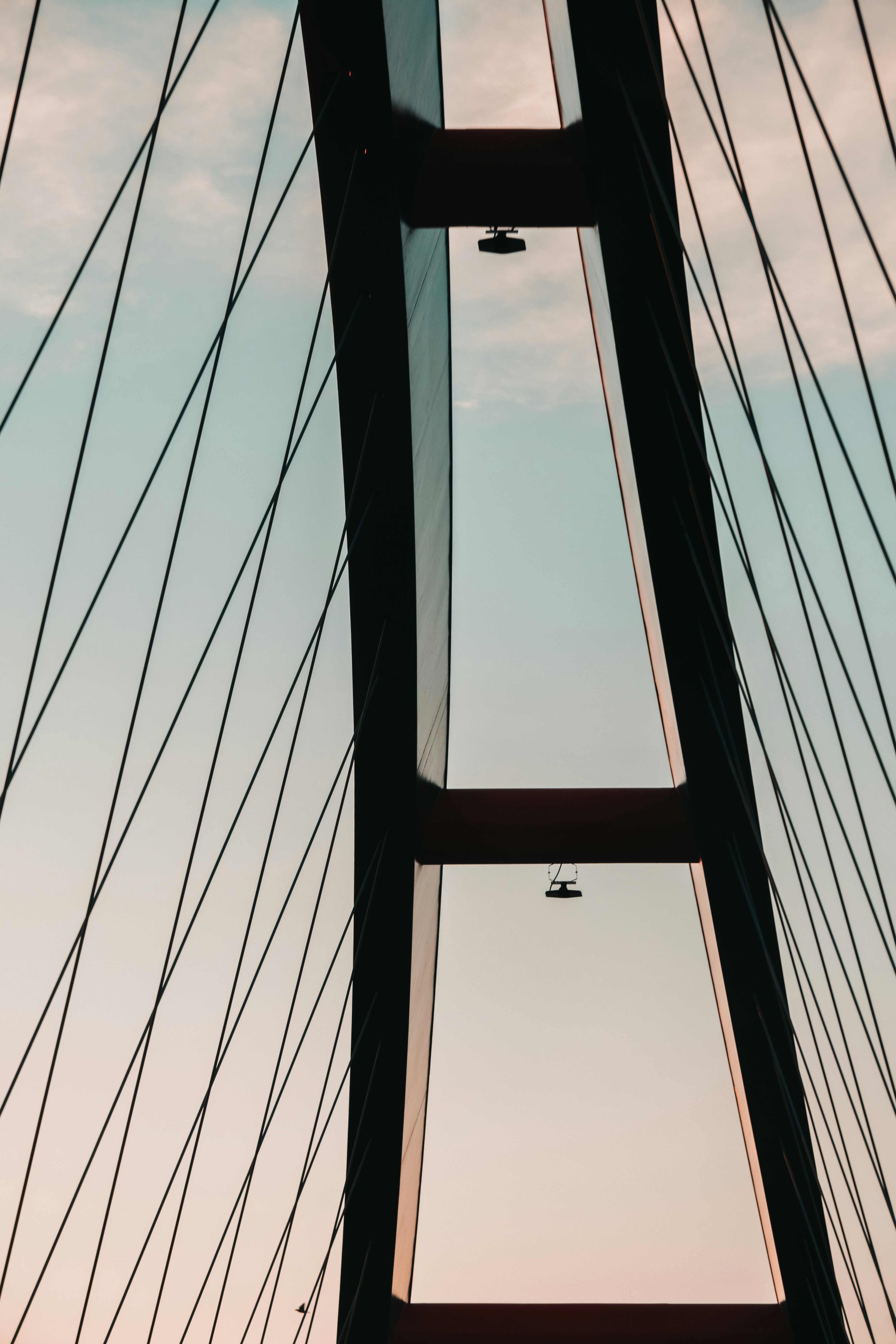 a plane flying through the air over a bridge