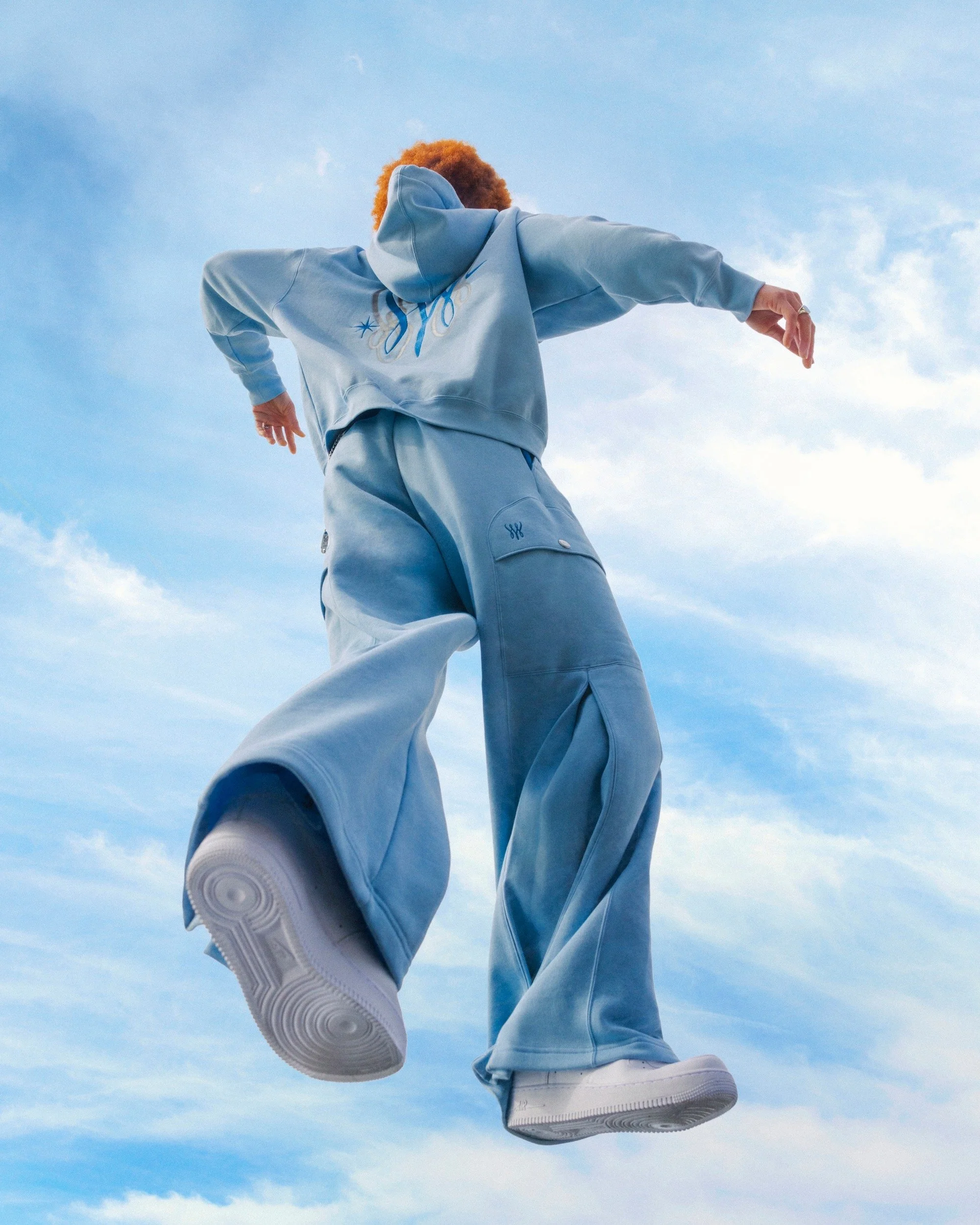 image of a person in blue jumping towards the sky
