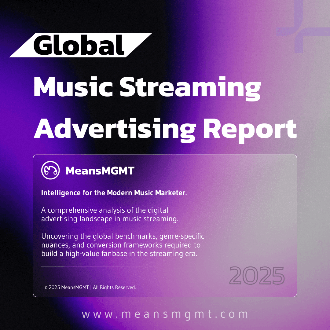 Woman working on a laptop computer at a table in a bright room.