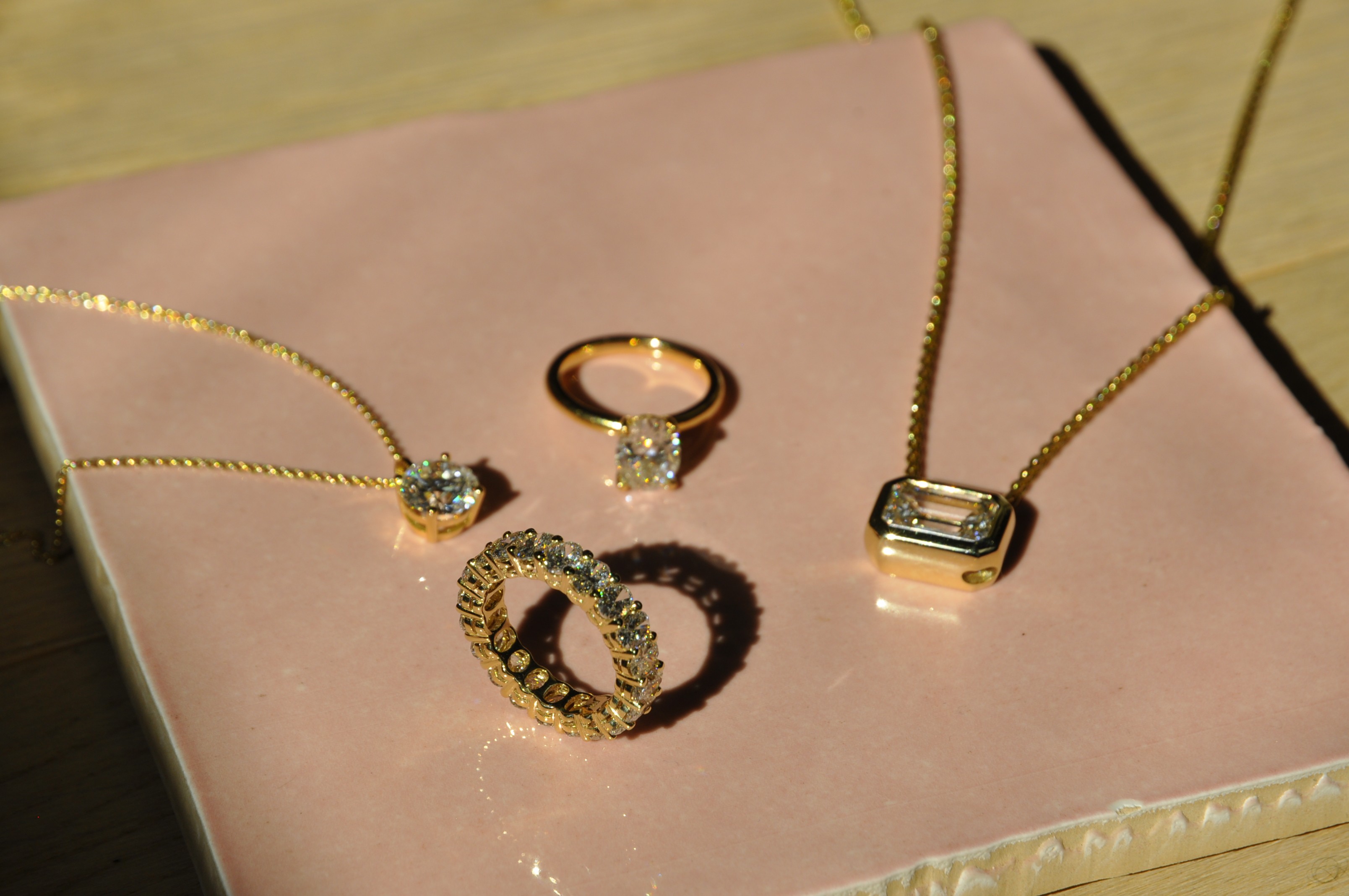 Tree branches reach towards a clear, blue sky.