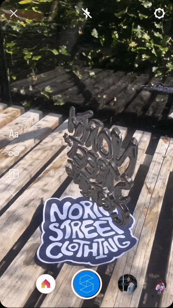 Instagram camera view of the chrome North Street Clothing logo spinning in augmented reality