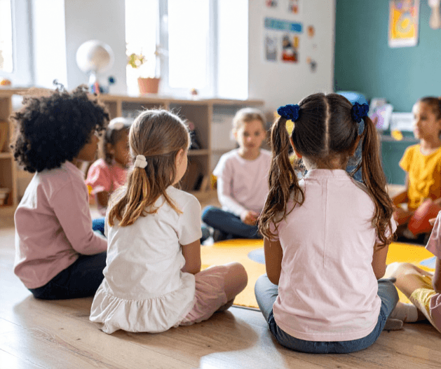 Children listening attentively during sound-first reading instruction aligned with the Orton-Gillingham approach, illustrating phonemic awareness development, decoding without guessing, and the foundations of automatic word recognition.