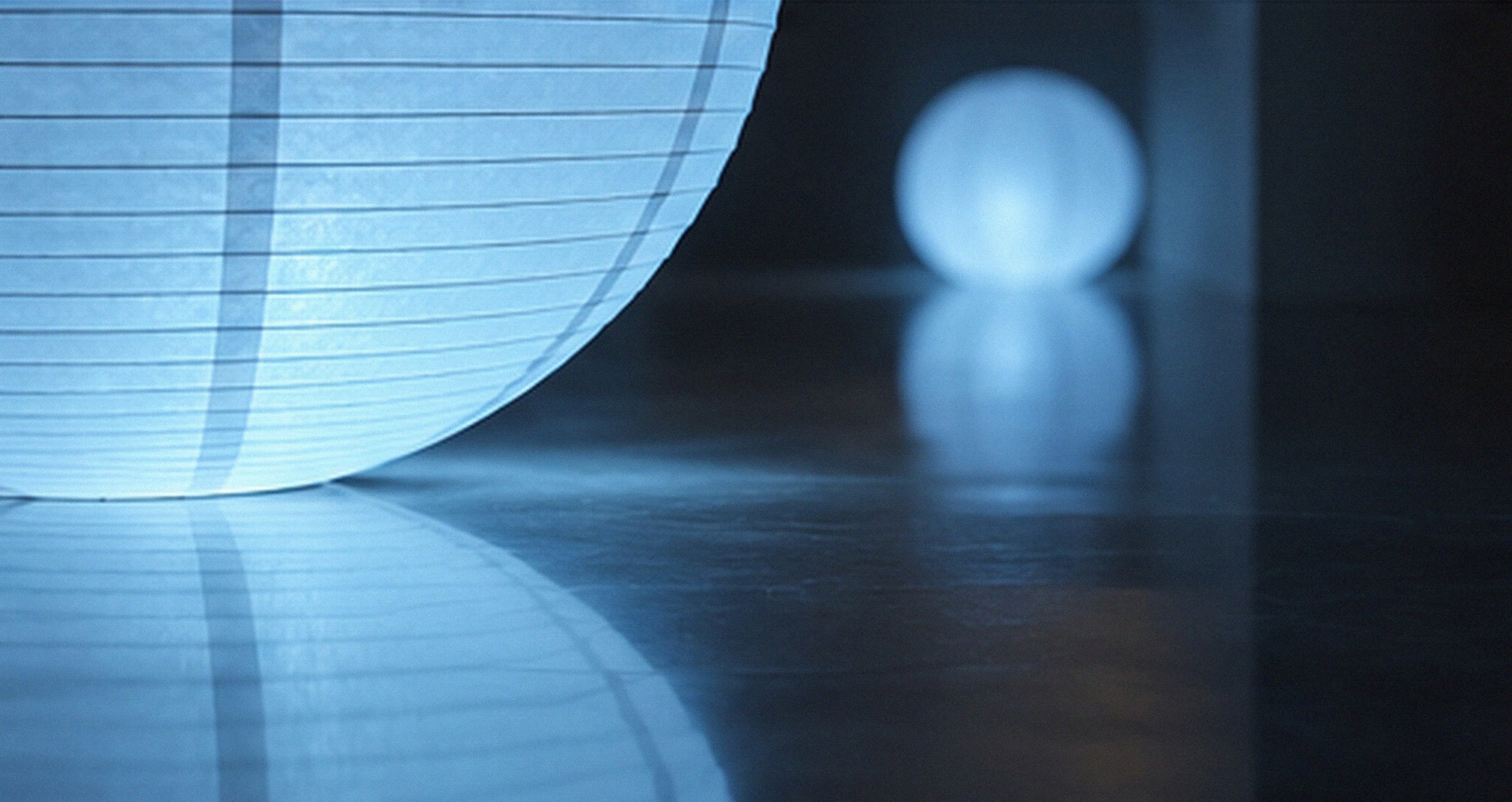 A sphere reflected in a polished floor