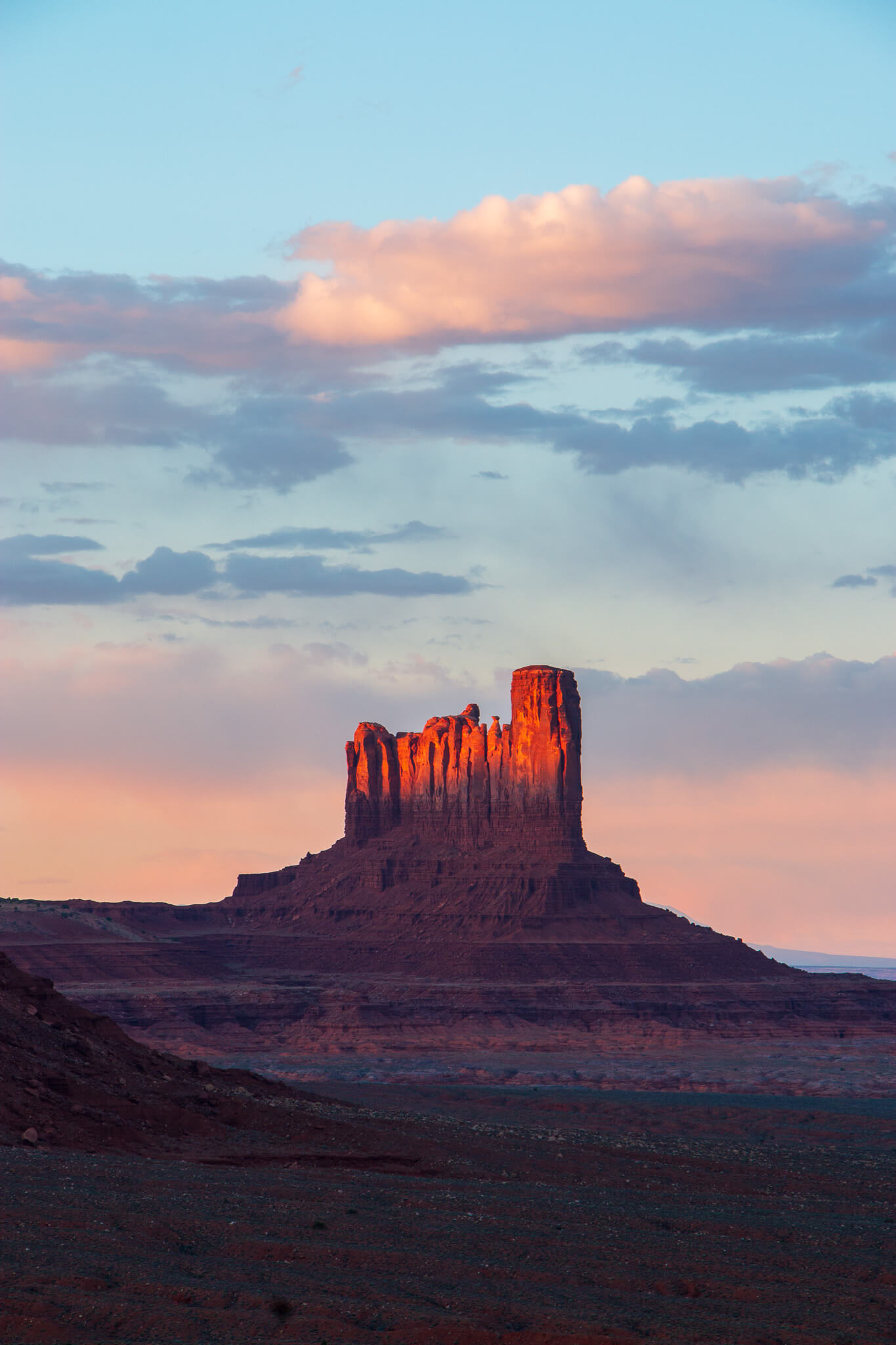 a single butte colored in the sunset