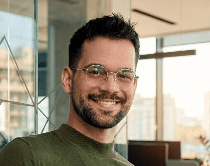 woman in red cardigan smiling