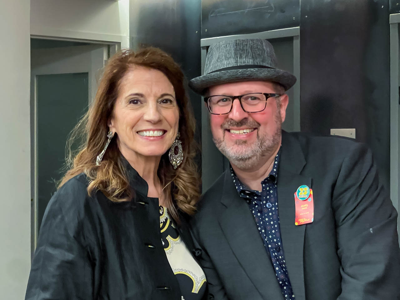 two people at a cocktail party looking at the camera