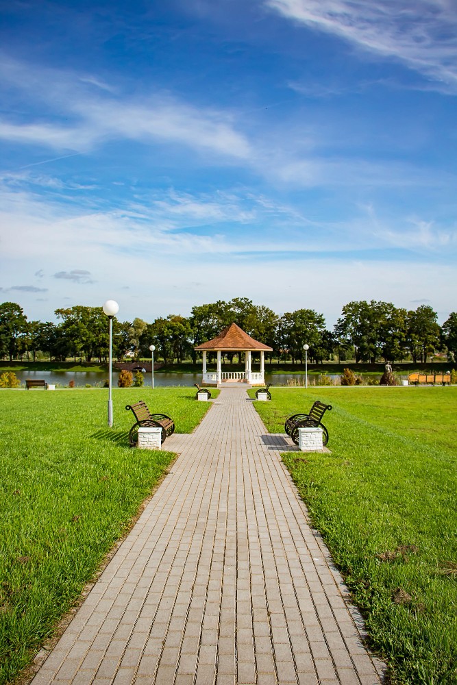 Stone church steeple rising above traditional half-timbered houses.