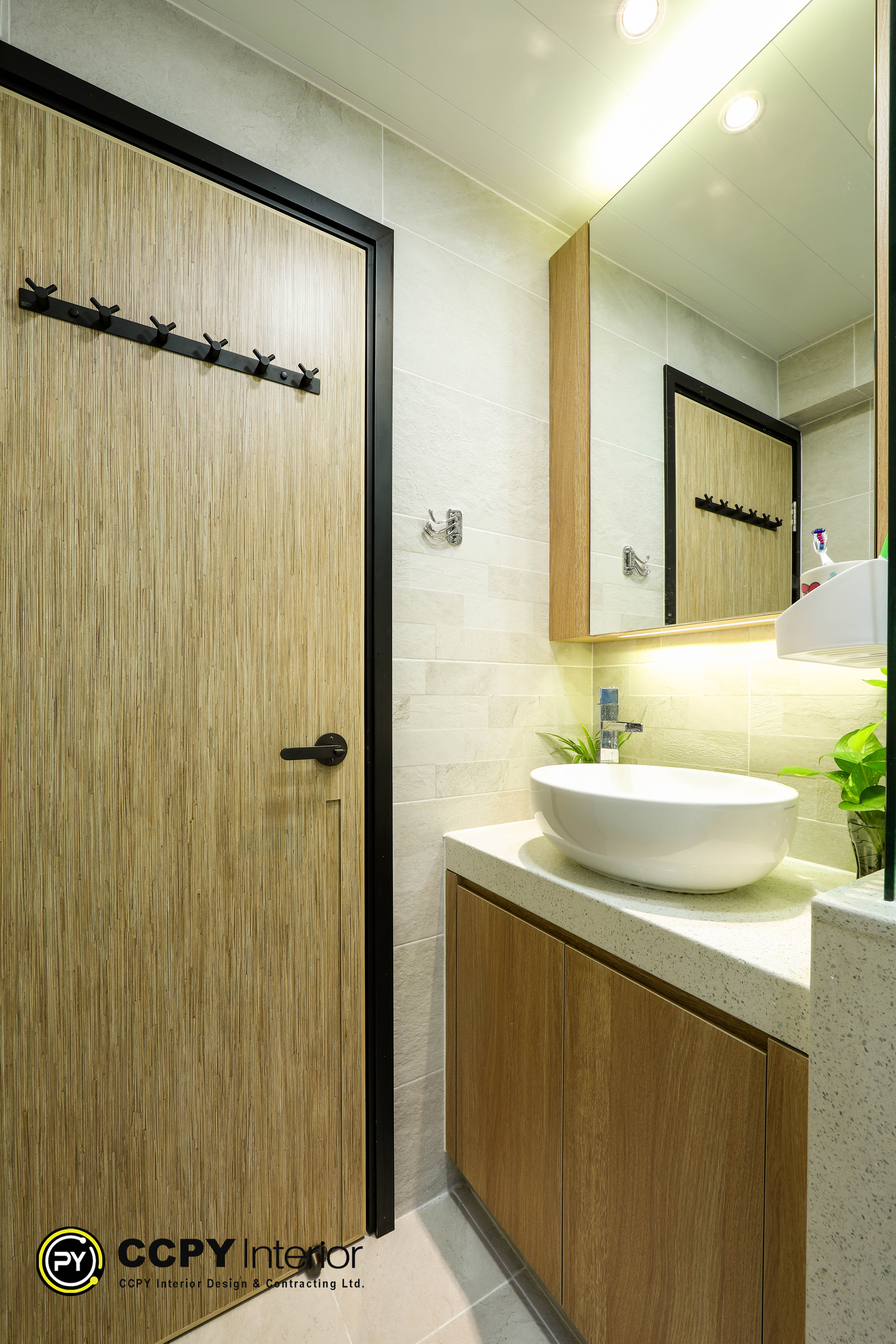 Modern bathroom featuring a white vessel sink, neutral stone-textured wall tiles, Panasonic heater, and a blue shower curtain in Kwan Lok Sun Chuen.