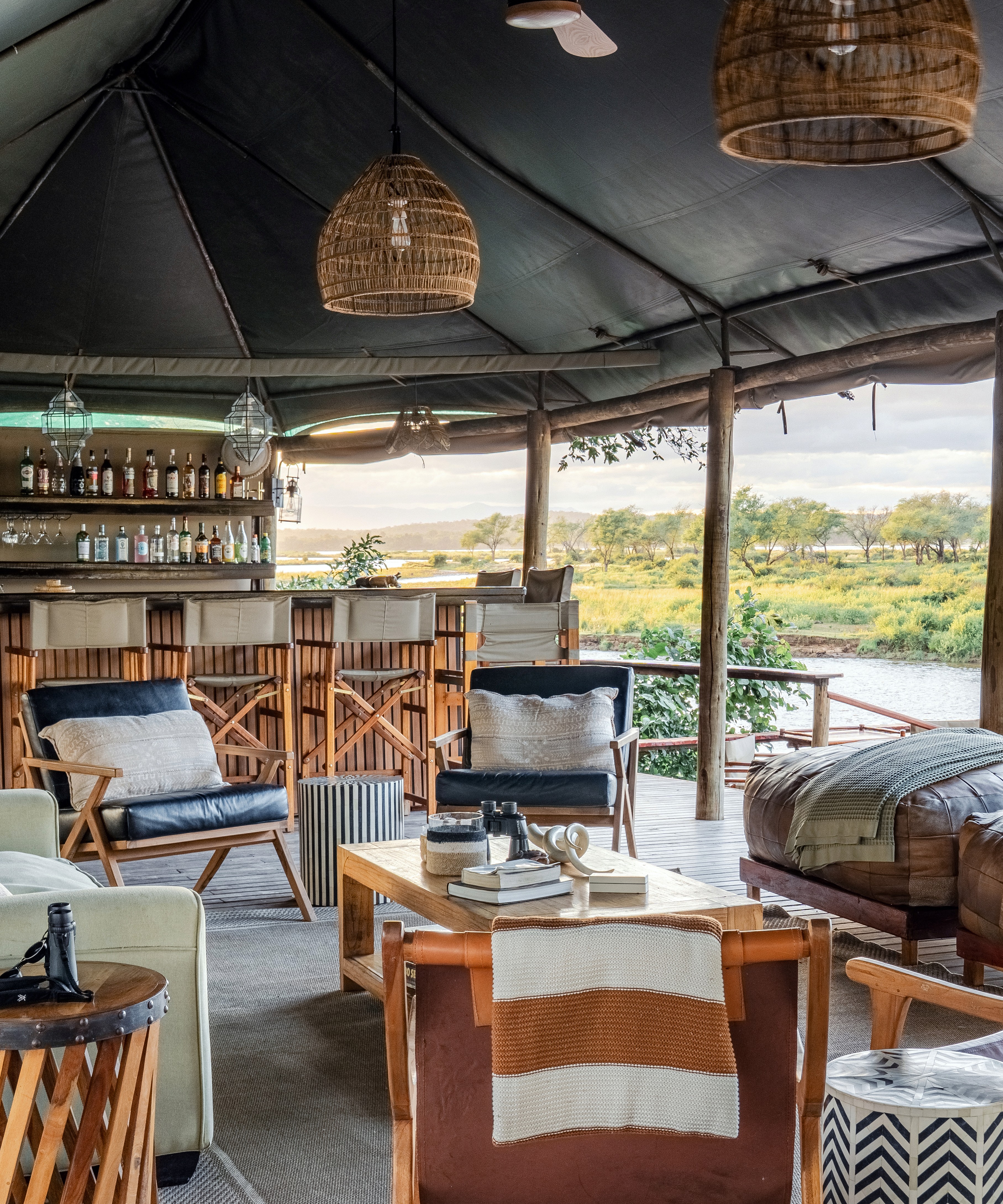 1. Main lounge and bar area at Amanzi Zambezi luxury tented camp, Lower Zambezi National Park, Zambia. 2. Scenic view of the Zambezi River from Amanzi Zambezi luxury tented camp, Lower Zambezi National Park, Zambia. 3. Luxury and style interior of lounge and bar at Amanzi Zambezi luxury tented camp, Lower Zambezi National Park, Zambia.