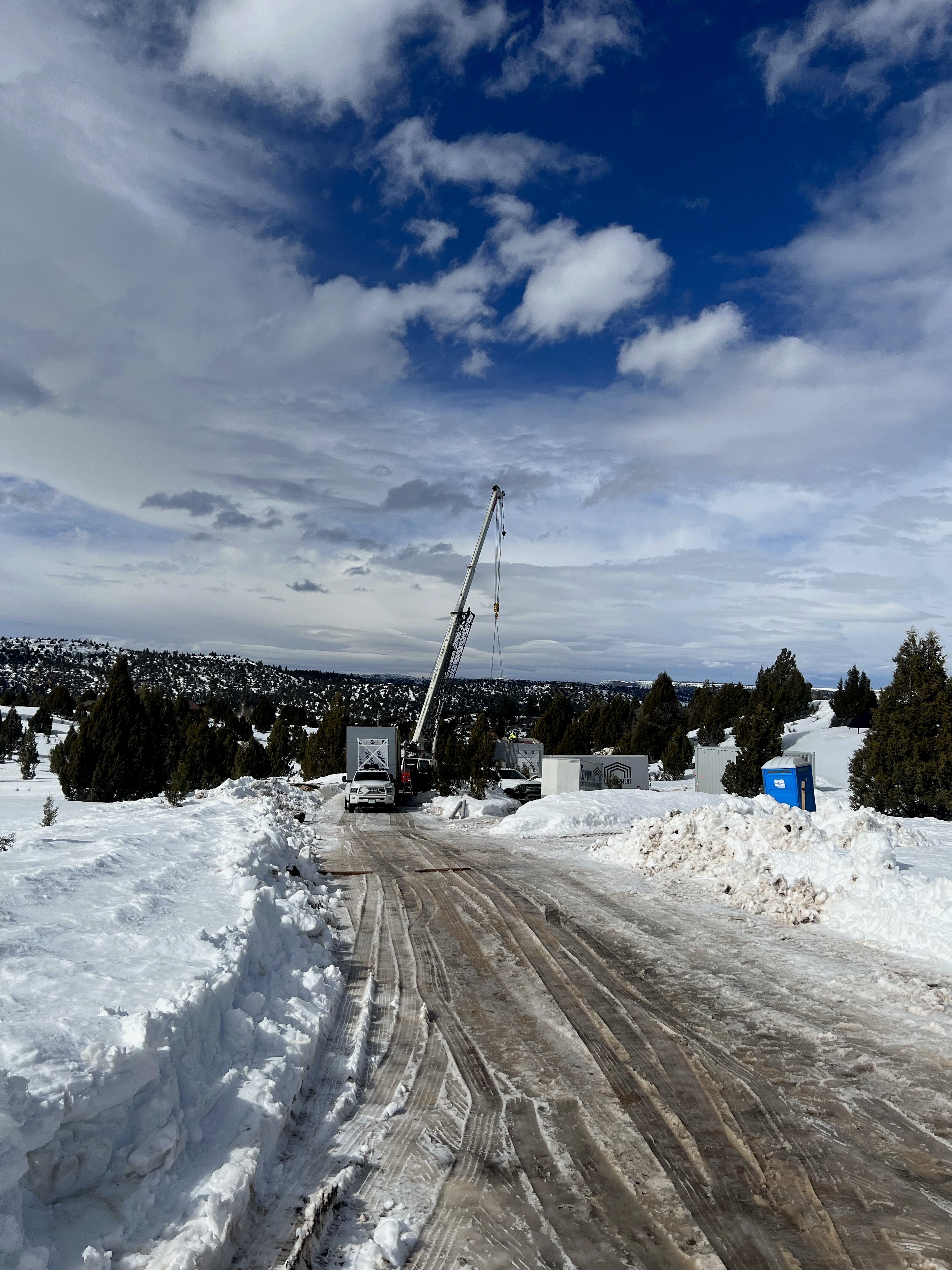 Crane about to lift a modular home in the winter.
