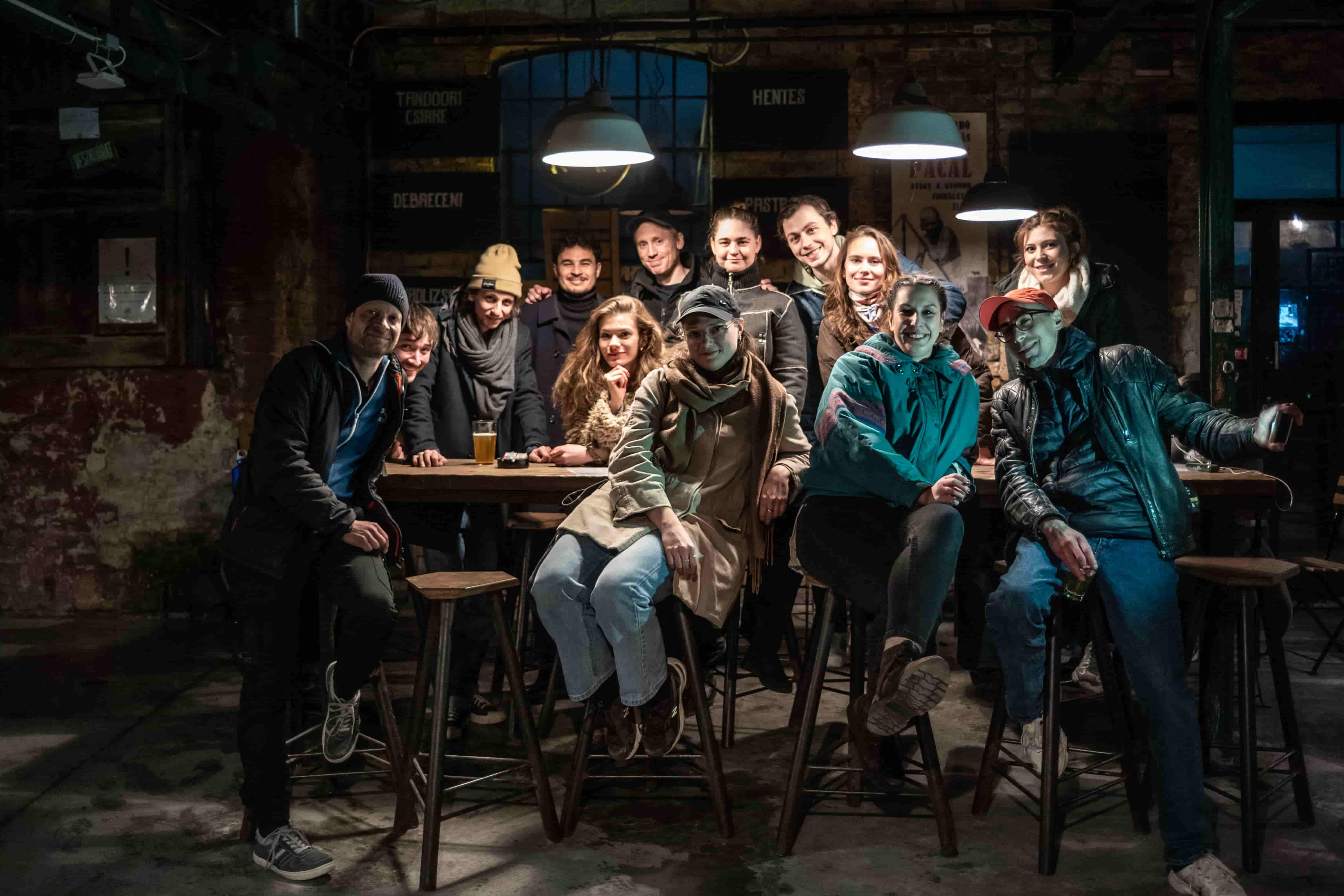 A green butterfly rests on a flower.