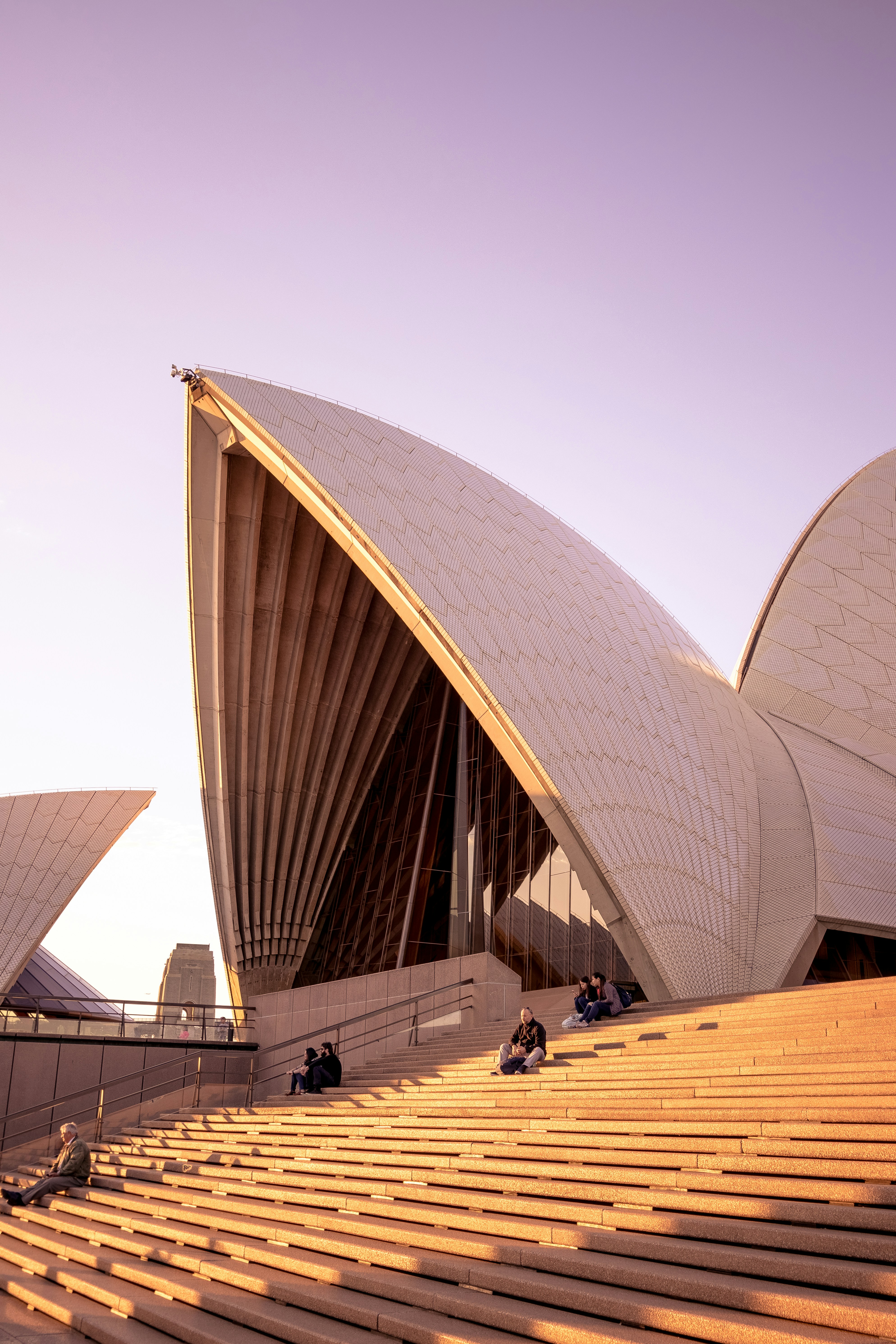 people sitting on bench on Sydney Opera House during daytime