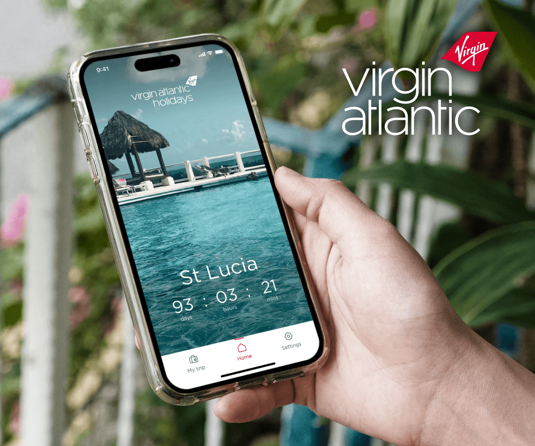 Image of a person holding their iphone which displays the virgin atlantic home screen counting down to their holiday in St Lucia