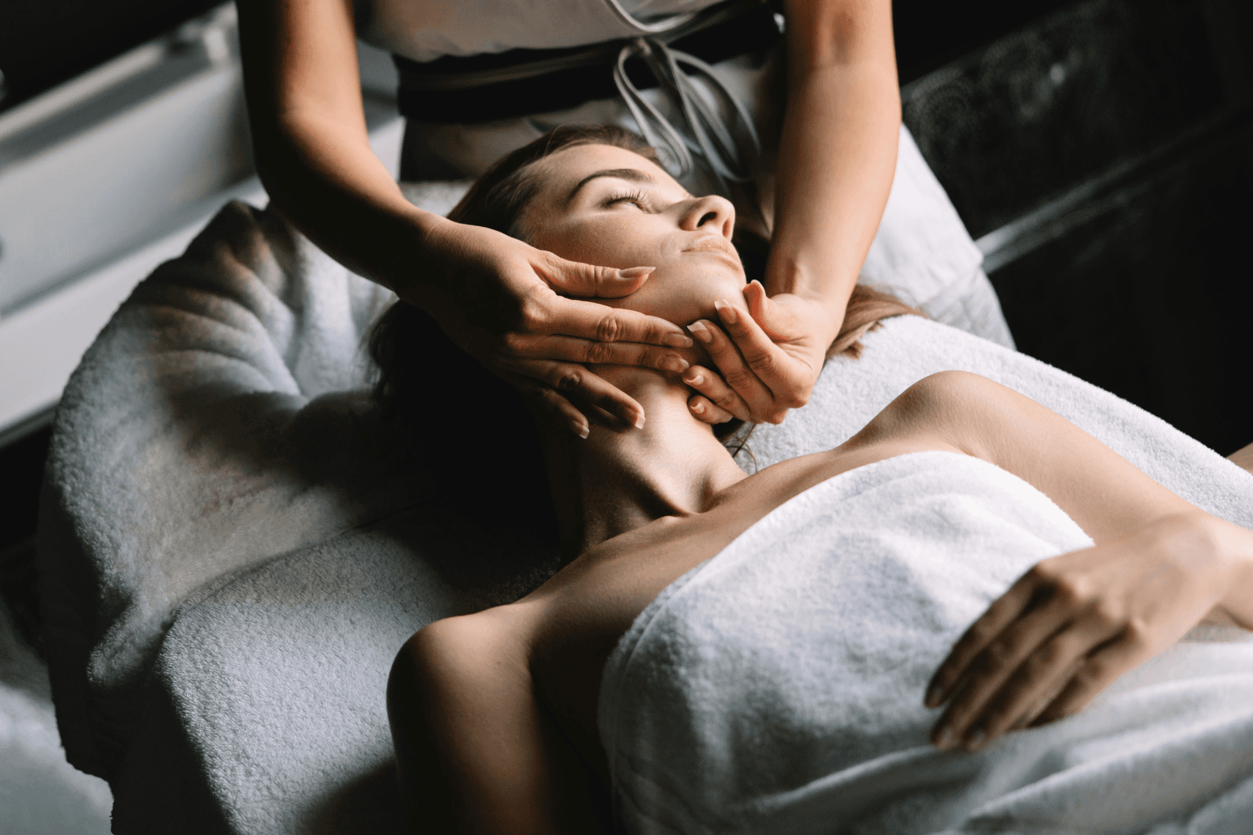 Woman receiving buccal massage from a Treatment Specialist