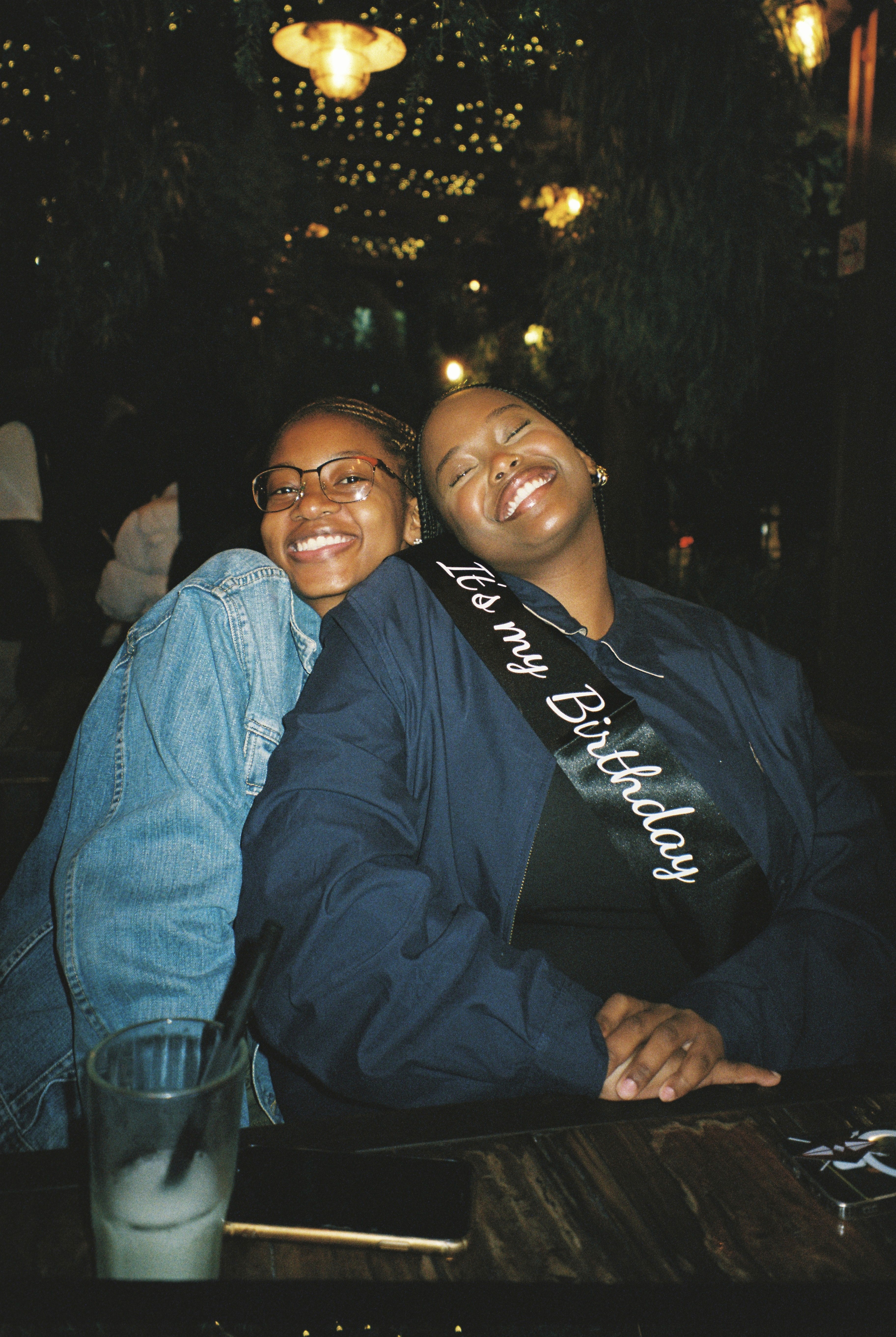 A green butterfly rests on a flower.