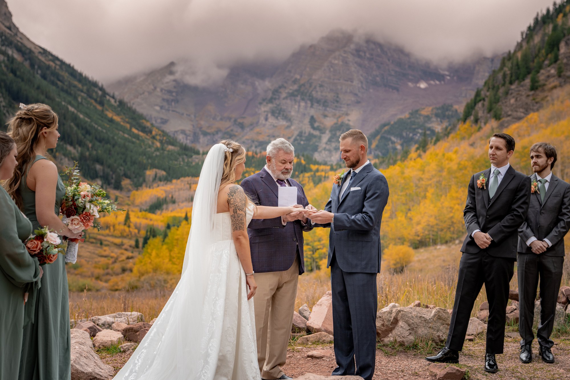 Couple facing each other during their Maroon Bells Amphitheater wedding ceremony