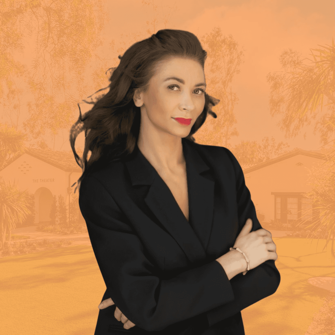 Smiling woman in beige yoga outfit sitting in natural light with green plants in the background.