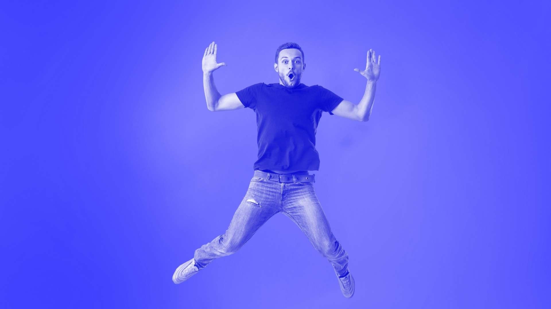 A man jumping in the air with arms and legs out