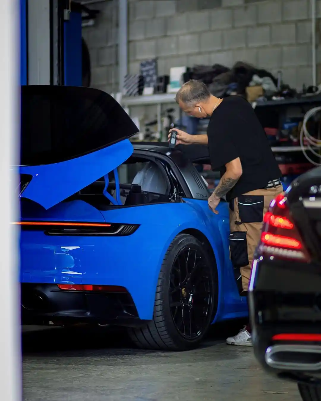 Mechanic repairing car engine.