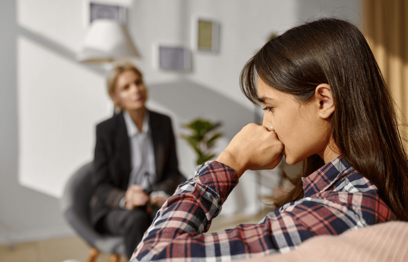 pensive woman at psychologist counseling session