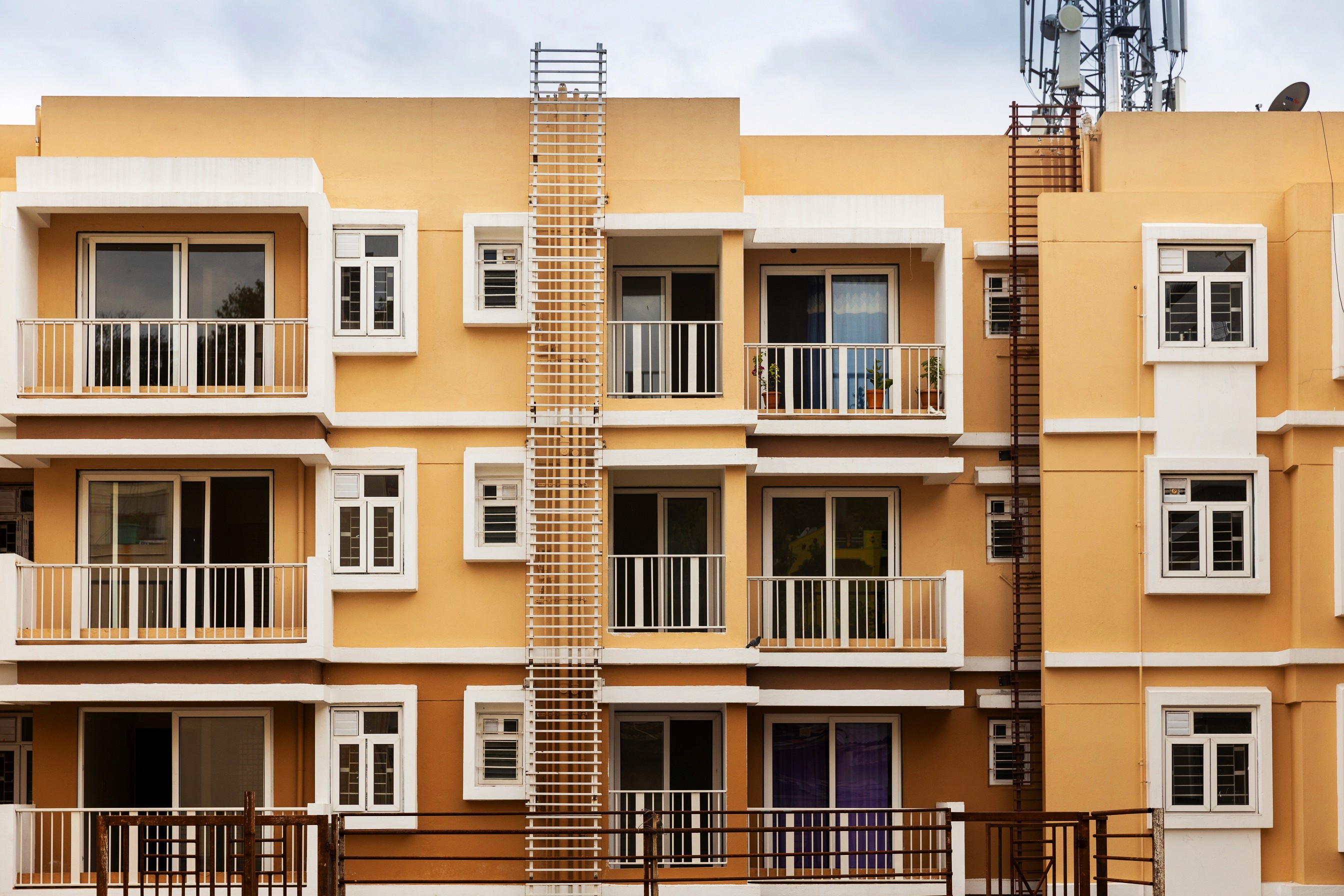 Aerial view of a winding road cutting through rocky terrain and sandy landscape.