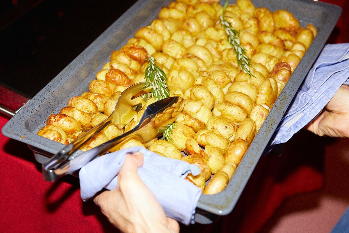 Employee holding a tray of fried potatoes