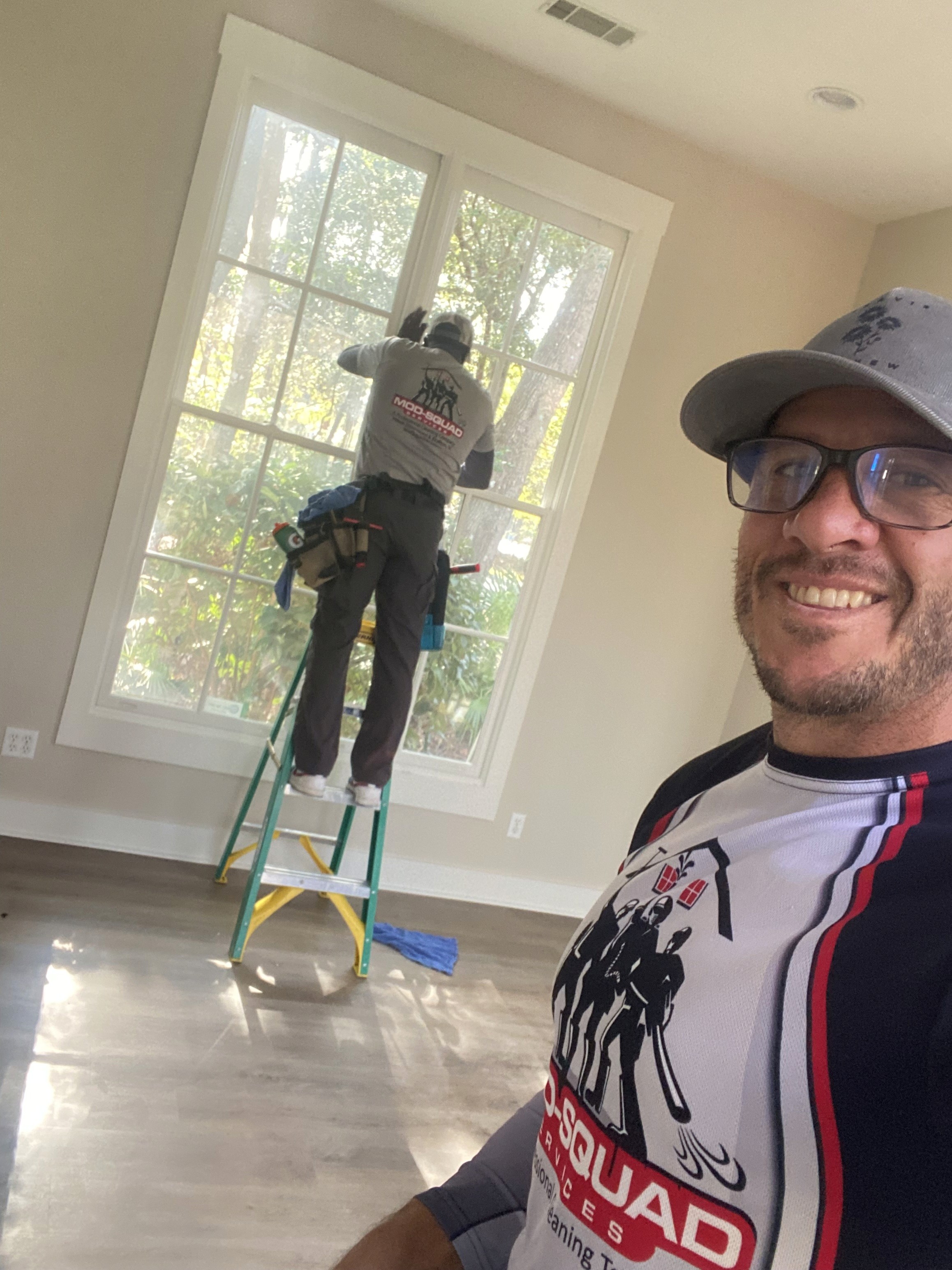 Window glass with hard water spots before cleaning service.