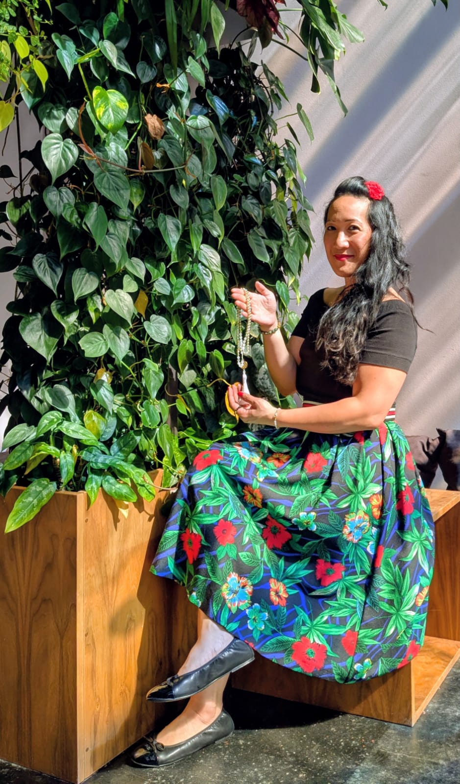 A close-up of a serene face illuminated by soft light, with shadows creating a patterned effect across the skin.