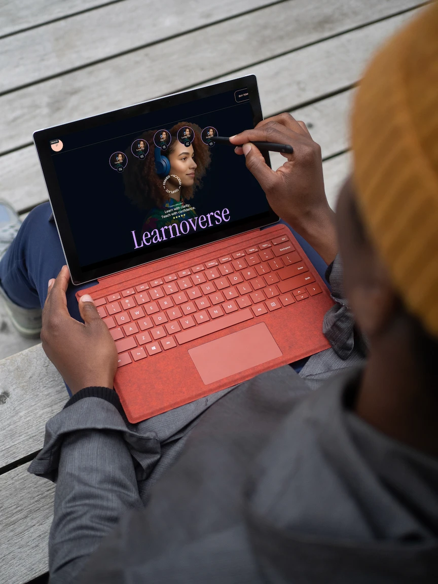 An image shows a student using the Learnoverse landing page on a laptip and using a digital pen